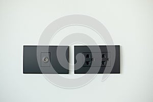 Black electrical outlet and inserts the antenna cable to the TV outlet