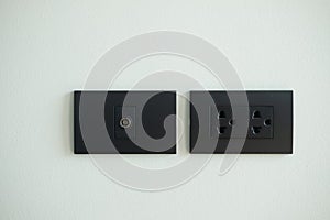 Black electrical outlet and inserts the antenna cable to the TV outlet