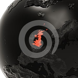 Black Embossed Earth Globe with Europe Close-Up. The United Kingdom is Highlighted in Red in The Center.