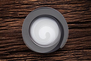 Black empty bowl on wooden table background