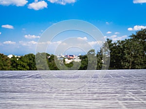 Black Empty wooden table in front of blue sky and city view