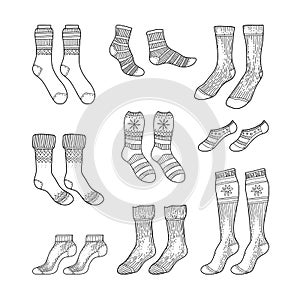 Black engraved socks drawing. Winter warm Christmas stockings set in ink hand drawn style vector illustration