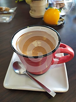 Black espresso coffee in a golden glass, eaten in a garden at home in Thailand, has a bitter taste, refreshing, very tasty.