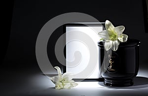 Black evangelical urn with blank mourning frame, and flower