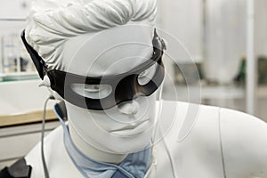Black eye patch, medical sensors and equipment on mannequin. Modern treatment technologies