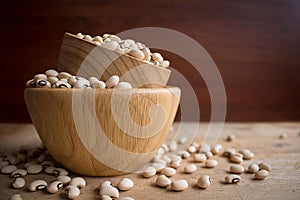 Black eyed beans in wooden bowl on rustic table