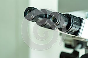 Black eyepieces of the microscope in the laboratory for viewing small items. Close-up.