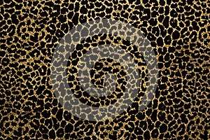 Black fabric with golden leopard fur print photo