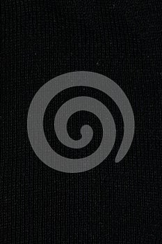 black fabric surface, small stitches as background. Structure of dark fabric as pattern backdrop