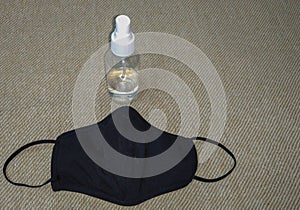 black Face mask and transparent sanitizer liquid spray bottle for protection from covid19 coronavirus