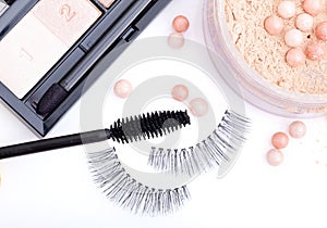 Black false eyelashes with mascara and powder photo