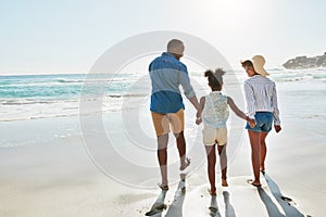 Black family, beach and walk during summer on vacation or holiday relaxing and enjoying peaceful scenery at the ocean