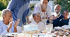 Black family, birthday party and clapping for a boy child outdoor in the yard for a celebration event. Kids, applause