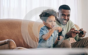 Black family, dad and child playing video games on living room sofa together with controllers at home. Happy African