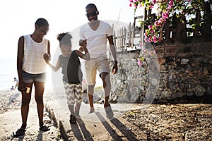 Black family enjoying summer together at the beach