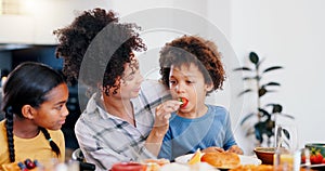 Black family, fruit and mother with children for breakfast, lunch and eating together in home. Happy, parents and mom