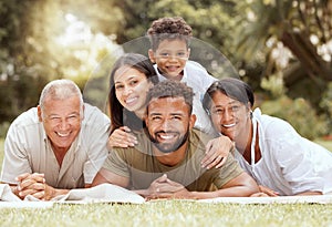 Black family, happy lying portrait on lawn blanket and summer sunshine in garden together on grass. Mom dad, child