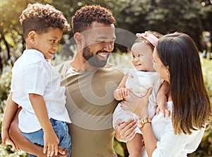 Black family, happy and nature park with people holding a child and baby outdoor. Mother, father and children together