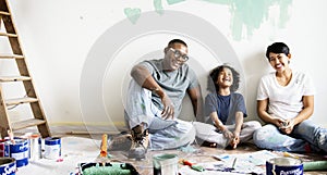 Black family painting house wall