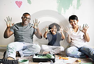 Black family painting house wall