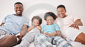 Black family, smile and portrait of parents with children on bed for bonding, quality time and relax together. Love