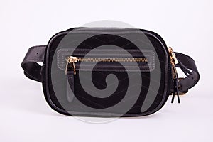 Black fashionable suede women`s waist bag on a white background.