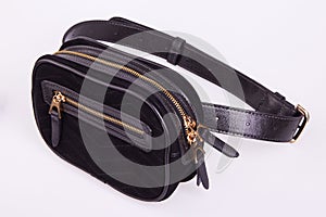 Black fashionable suede women`s waist bag on a white background.
