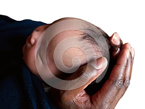 Black father holding newborn baby`s head in his hands. photo