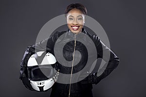 Black Female Biker in Leather Jacket Holding a Helmet