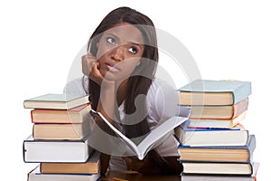 Black female college student by stack of books