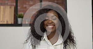 Black female creative standing in an office turning and smiling