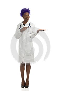Black Female Doctor Is Standing With Hand Raised And Pointing. Front View. Full Length, Isolated