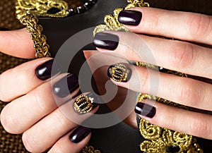 Black female manicure nails closeup with crown