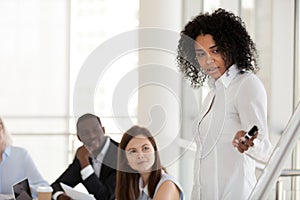 Black female mentor make presentation on flipchart training empl