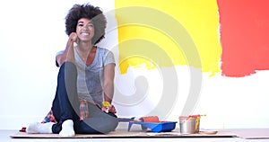 Black female painter sitting on floor