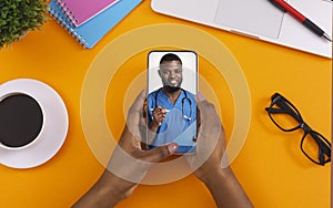 Black female patient having online consultation with doctor via video call