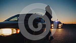 Black Female Police Officer Stepping Out of Patrol Car and Heading Towards a Pulled over Car. Cop