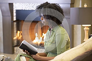 Black Female Reading a Book in a Living Room