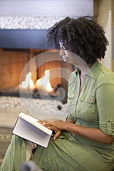 Black Female Reading a Book in a Living Room