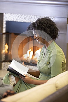 Black Female Reading a Book in a Living Room