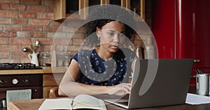 Black female student learn online using laptop write up information