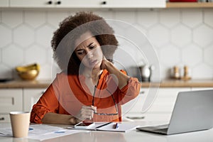 Black Female Suffering Neck Pain After Working With Laptop At Home Office