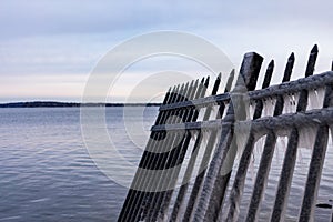 A Black Fence Covered in Ice on on the Shore of Lake Mendota in Madison Wisconsin