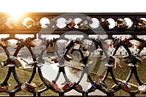 Black fence with a lot of locks.