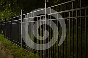 Black Fence at Night. Fence in dark. Steel profile