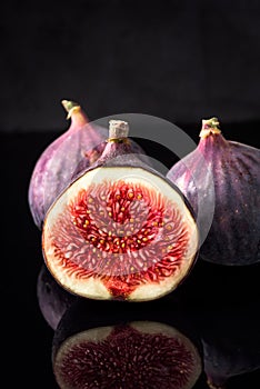 Black figs on black board and dark reflections