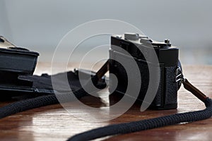 Black film camera with its lace and leather case