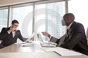 Black financial consultant talking with investor