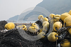 black fishing nets and yellow fishing buoys fender japanese harbor