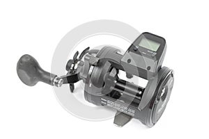 Black fishing reel baitcast isolated above white background